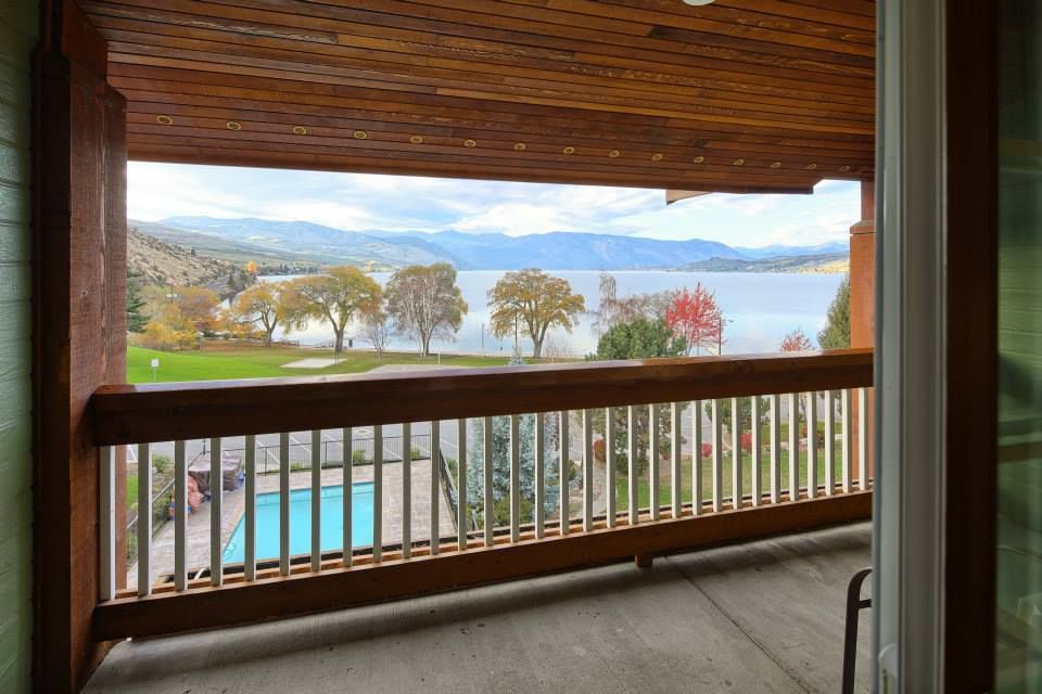 One of our favorite Chelan fall activities--relaxing on the balcony and enjoying the lake view. 

Image shows a balcony railing and beyond it, a swimming pool, Lakeside Park, a few trees and the beautiful Lake Chelan. Mountains rise in the distance.